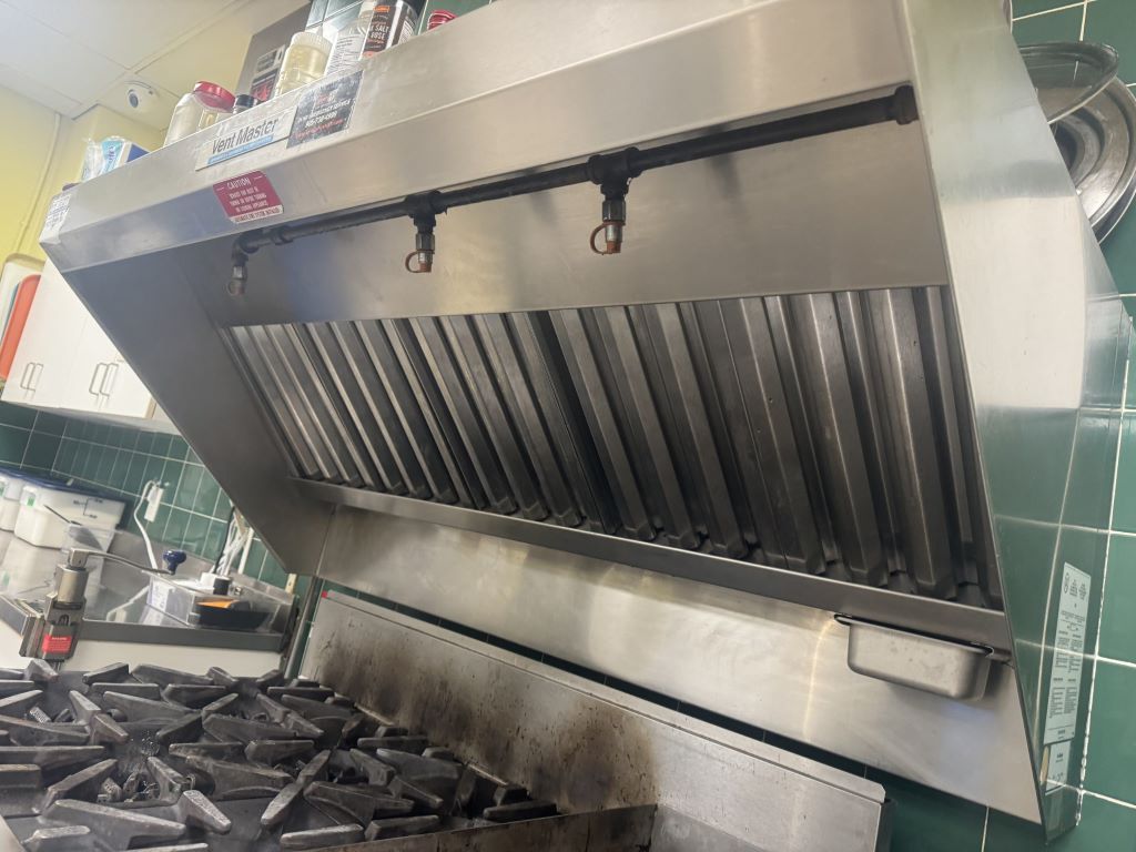 Polished NFPA 96 compliant kitchen hood after professional degreasing service